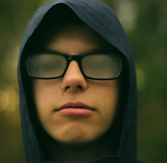selective focus photography of man wearing eyeglasses