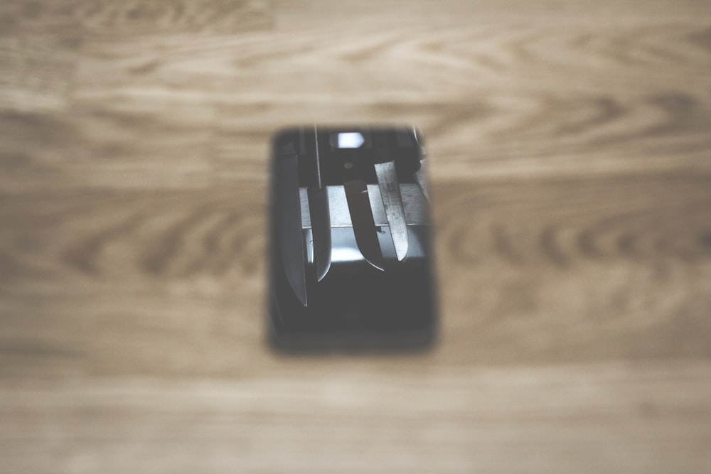 a wooden table with a knife and fork on it