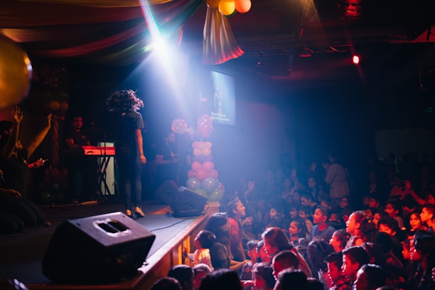 Colorful children's party scene with entertainers in costumes and happy kids.