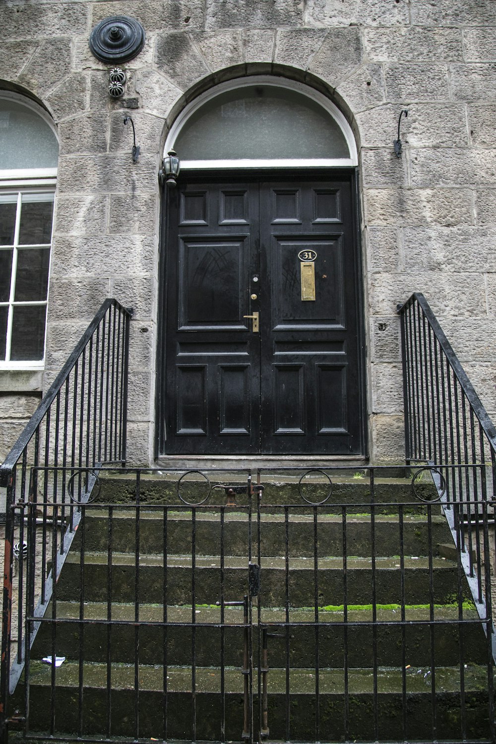 black wooden door on gray brick building