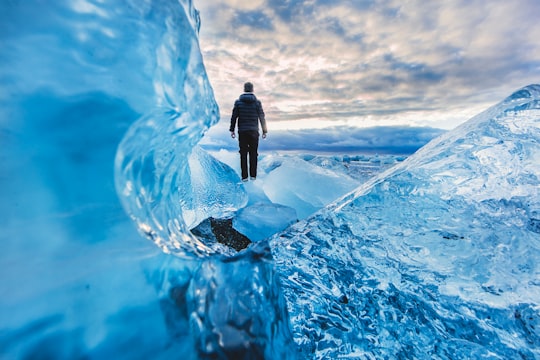 man floating on water photo edit in Jökulsárlón Iceland