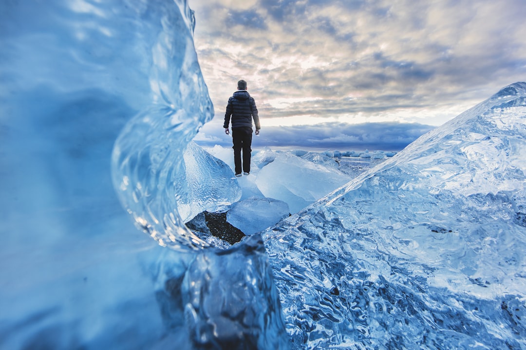 man floating on water photo edit, A freezing cold night camping on the ice beach next to Jökulsárlón was completely wort