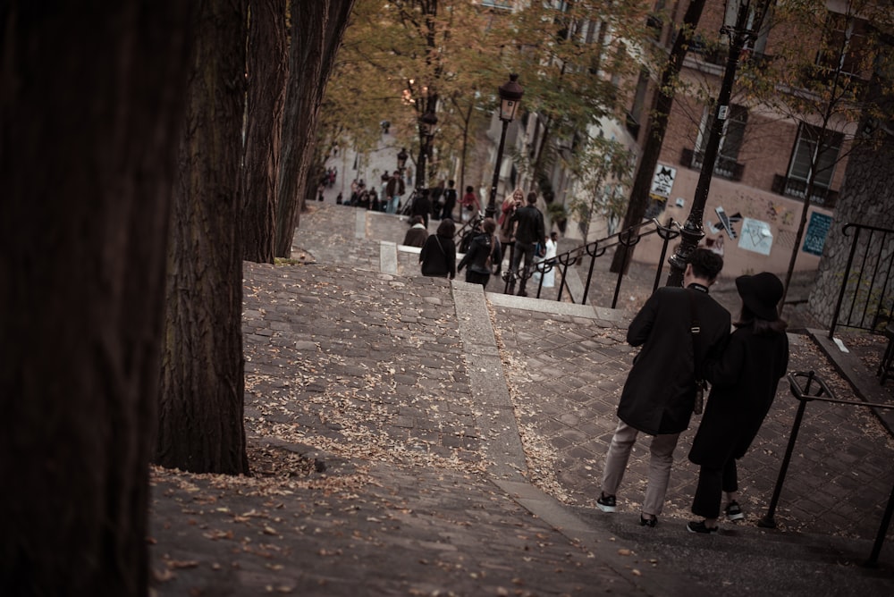 person walking on sidewalk surrounded by trees