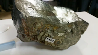 Raw lead concentrate samples displayed on a lab table for quality testing.