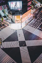 A nighttime shot of a busy intersection illuminated by Jerico’s striking outdoor ad installations.