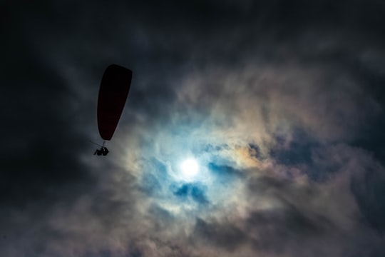 low angle photo of silhouette of man with parachute in Larcomar Peru