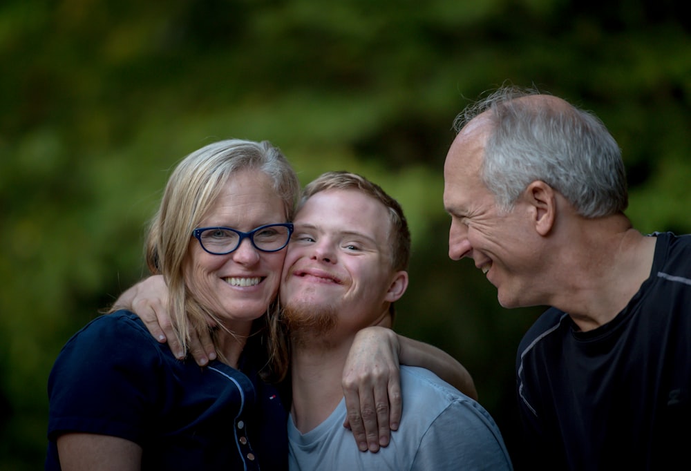 Mother, son, and father in casual shot smiling outdoors