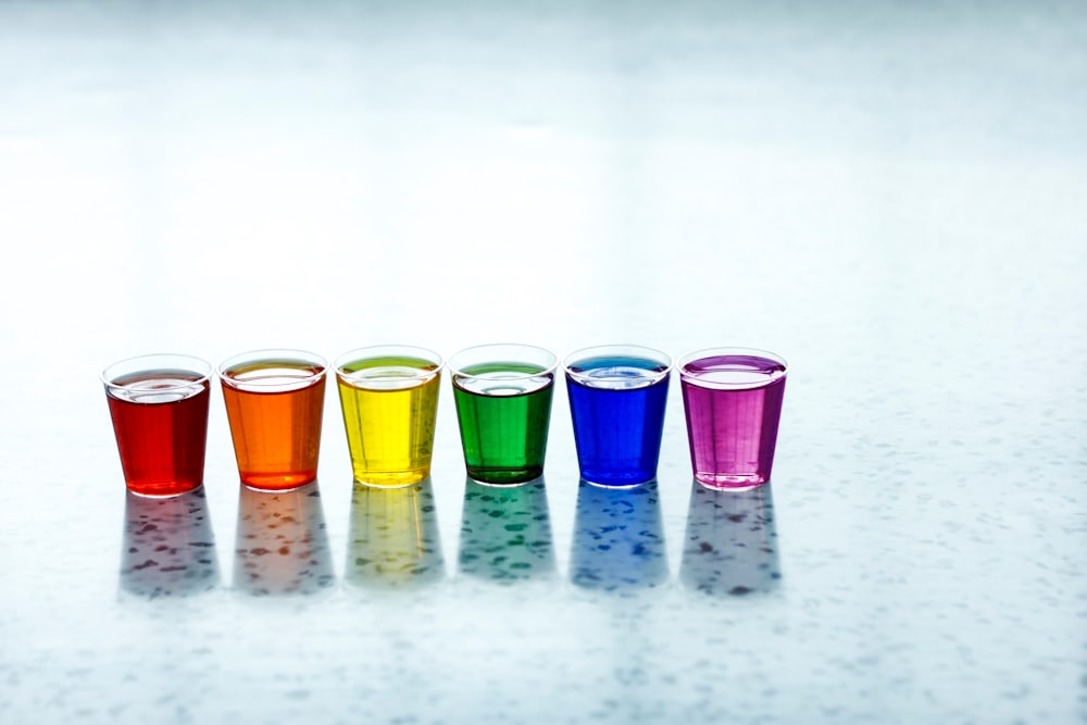 six assorted-color shot glasses