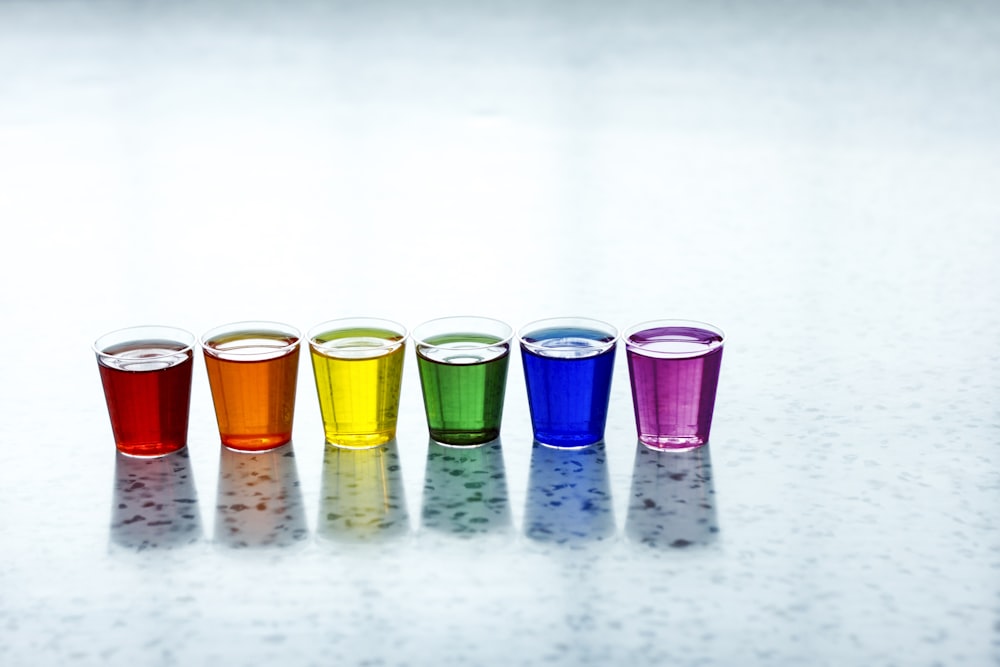 six assorted-color shot glasses