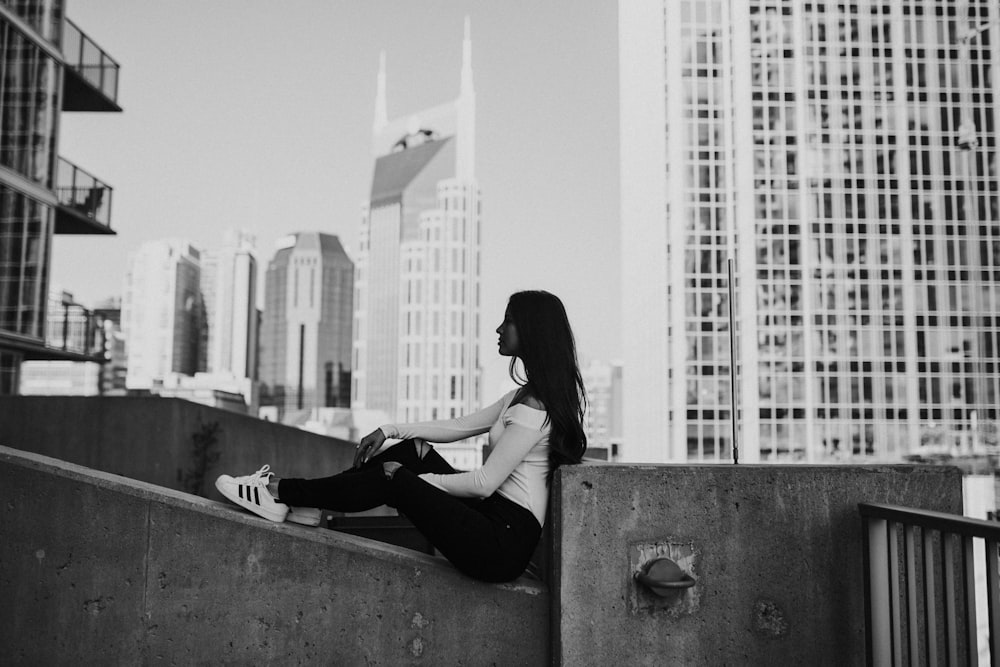 grayscale photography of woman sitting