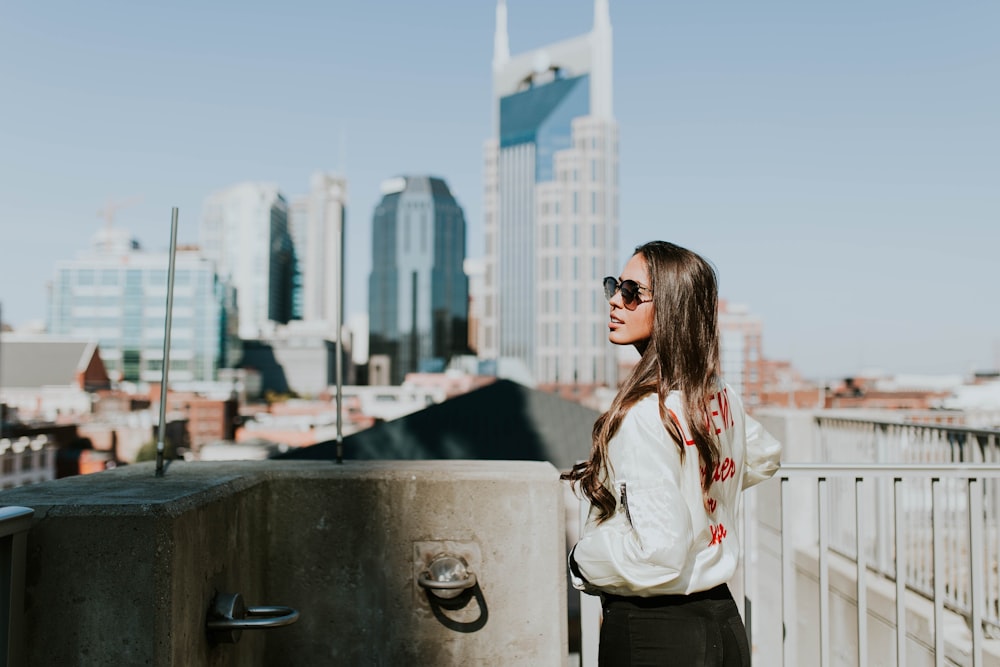 woman standing near hand rails during daytime