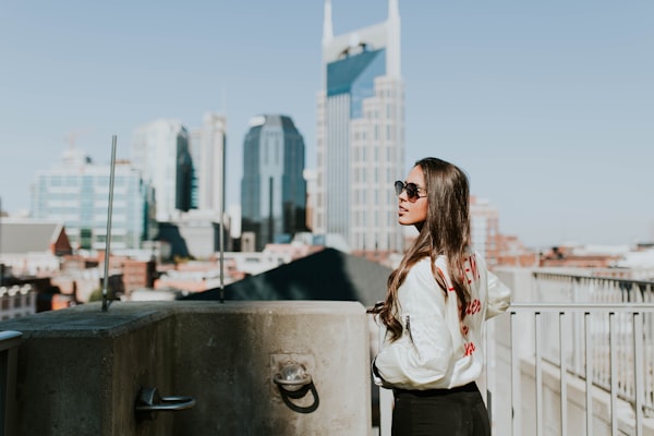 Passenger looking out airplane window over clouds