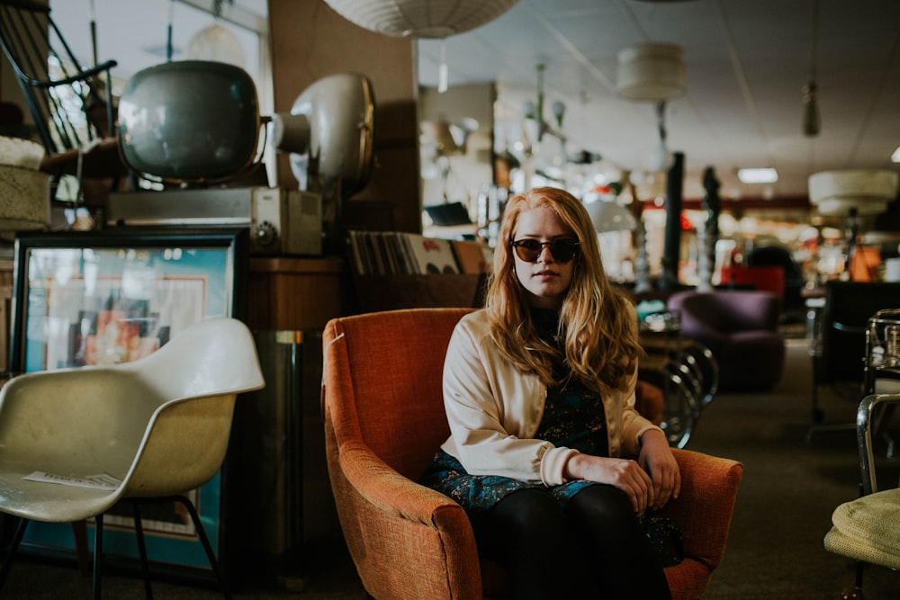 woman sitting on sofa wearing sunglasses