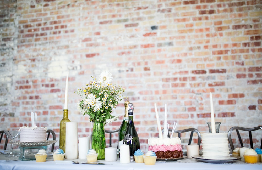 cake beside candles and flowers