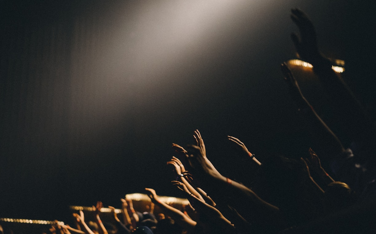 group of people waving their hands