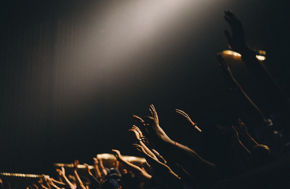 group of people waving their hands