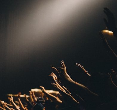 group of people waving their hands