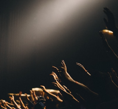 group of people waving their hands