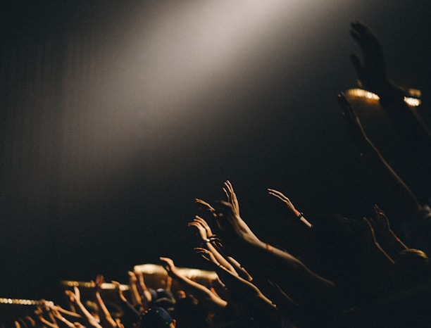 group of people waving their hands