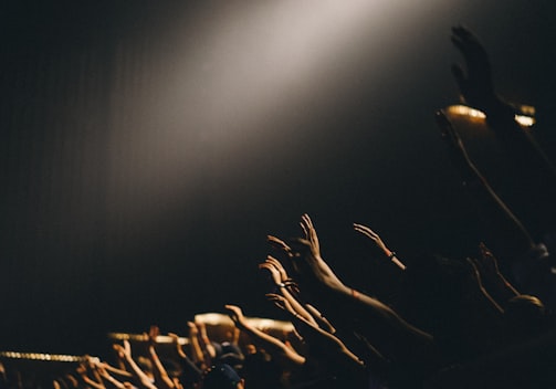 group of people waving their hands