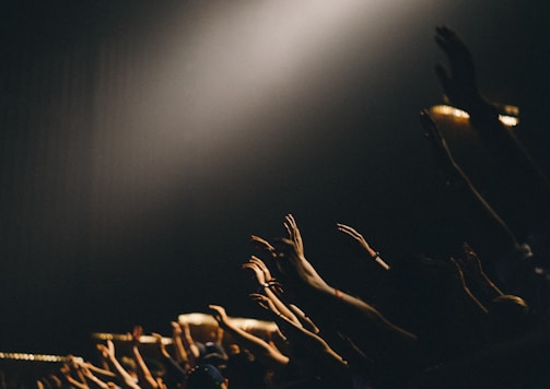 group of people waving their hands