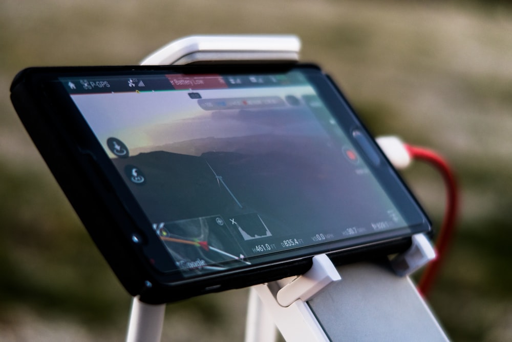 A close-up of a smartphone in a stand used as a car GPS system