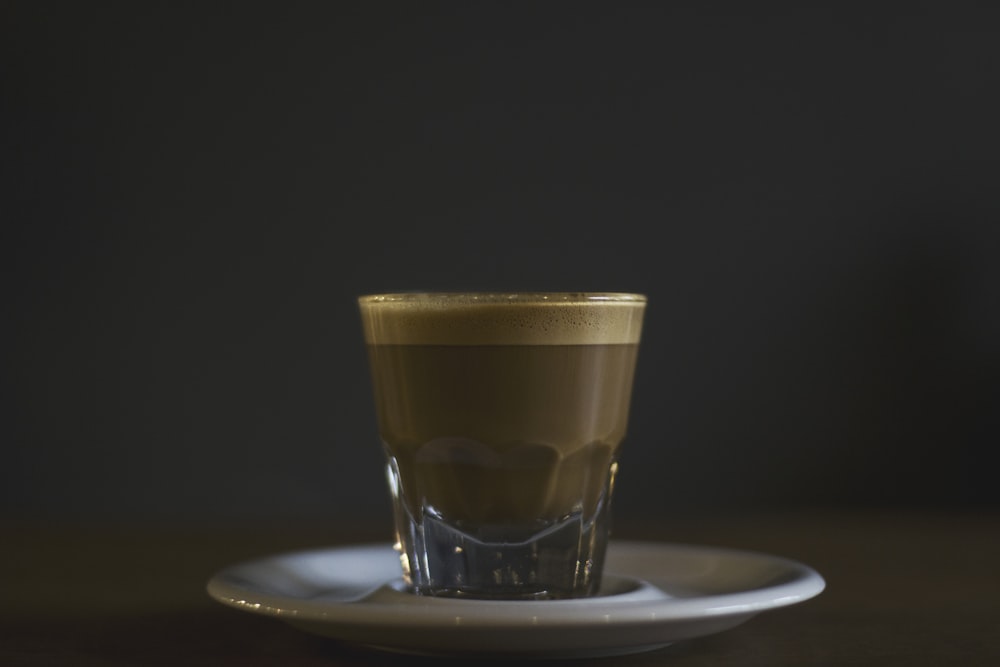 coffee filled rock glass on saucer