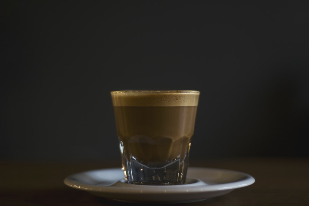 coffee filled rock glass on saucer