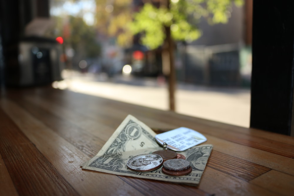 Coins sitting on top of a one dollar bill.