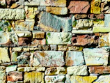 Artistic arrangement of palimanan stones forming a decorative wall with natural patterns.
