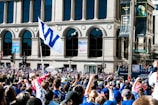 A vibrant crowd gathered outside Independence Hall, draped in royal blue and gold banners.