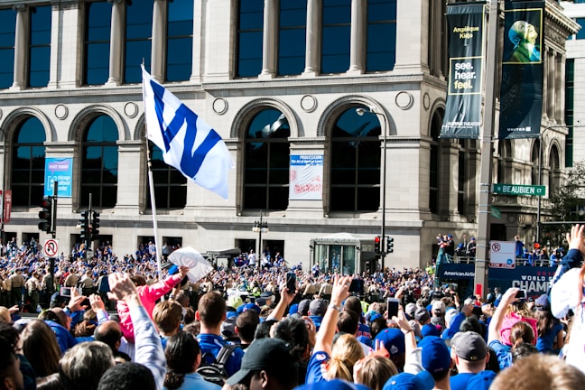 A vibrant crowd gathered outside Independence Hall, draped in royal blue and gold banners.