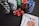 Stacks of poker chips in various colors including black, white, red, blue, and green are accompanied by red dice and a hand of playing cards featuring face cards such as the Queen and King of Clubs.