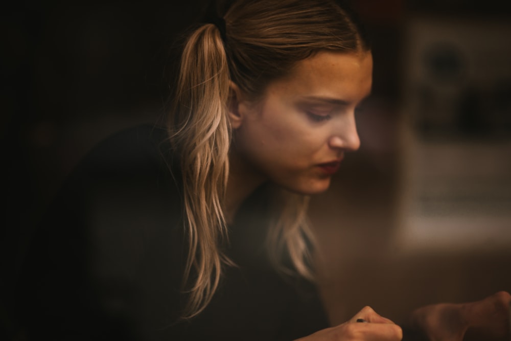 woman in black shirt looking down