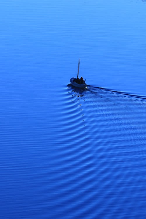 blue aesthetic sea with little boat
