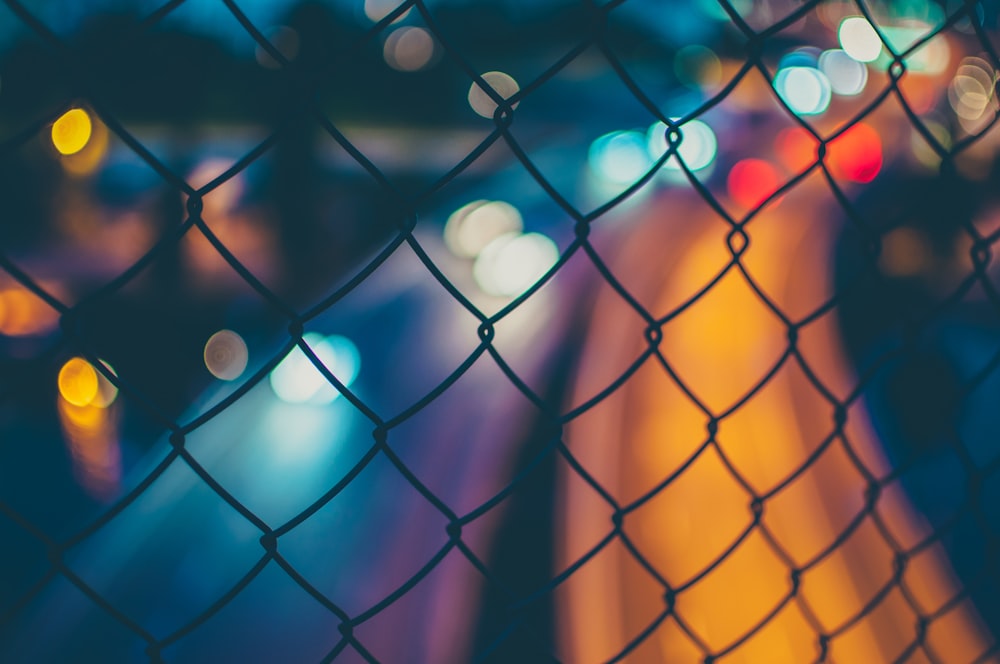 chain link fence with bokeh lights