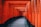 gray pathway between red and black wooden pillar