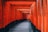 gray pathway between red and black wooden pillar