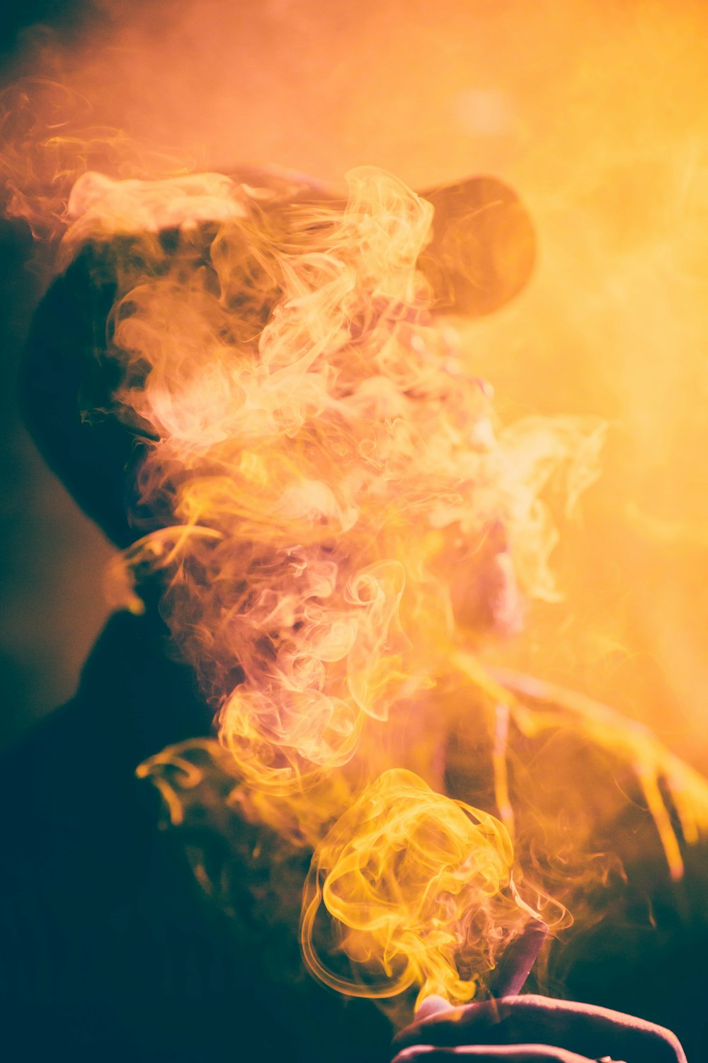 macro photography of man covered by cigar smoke