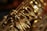 A close-up view of the intricate metal keys and mechanisms of a saxophone, showcasing its shiny gold finish and detailed craftsmanship.