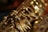 A close-up view of the intricate metal keys and mechanisms of a saxophone, showcasing its shiny gold finish and detailed craftsmanship.