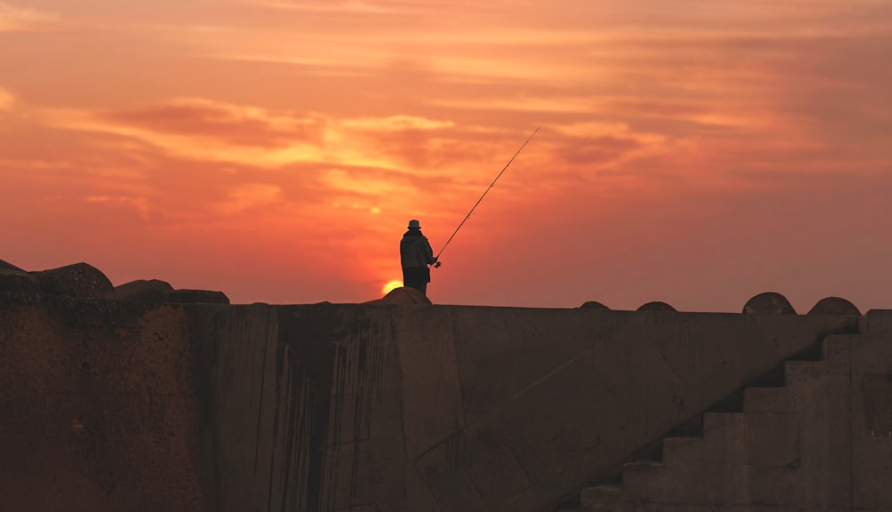 silhouette of person standing during golden hour