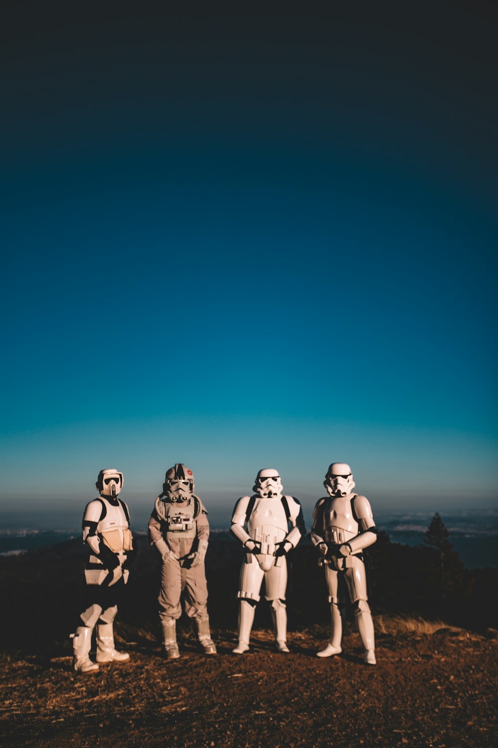 four person wearing Star Wars Clone Trooper costumes