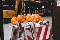 orange lights on top of white and red metal bars