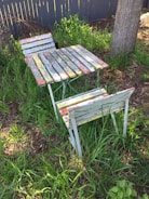 Handmade rustic wooden cornhole boards with natural finish set on the farm’s grassy area near wildflowers.