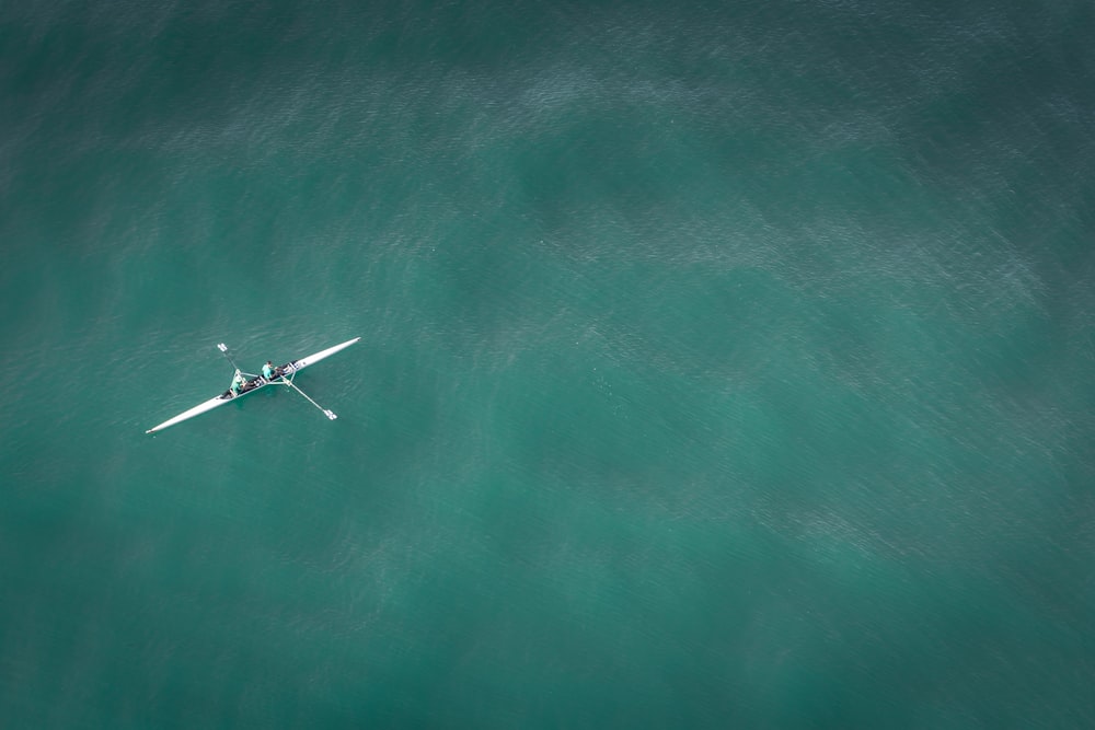 white canoe on body of water