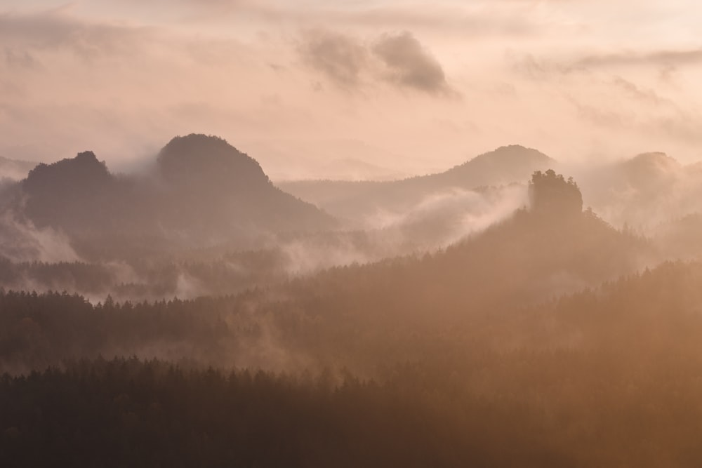 silhouette of mountain under white sky