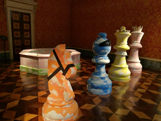 A colorful wall display featuring famous chess openings and tactics at the academy.