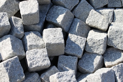 Stack of granite blocks ready for cutting in a warehouse.
