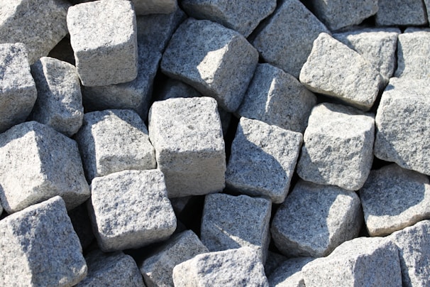 Stacked marble slabs in a warehouse ready for delivery, emphasizing quality and variety.